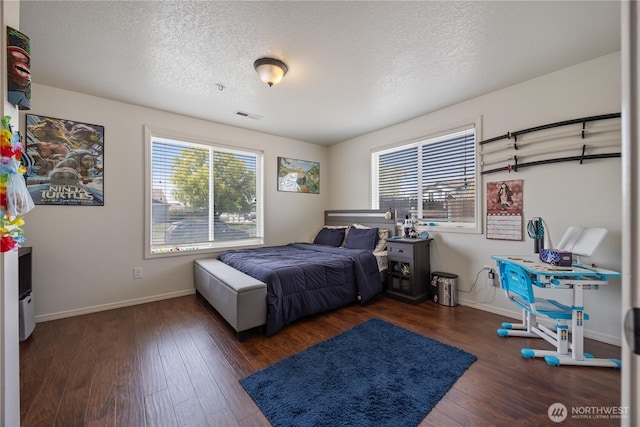 5421 Jackson Ln, Pasco, WA 99301 - bedroom with multiple windows, wood finished floors, and a textured ceiling
