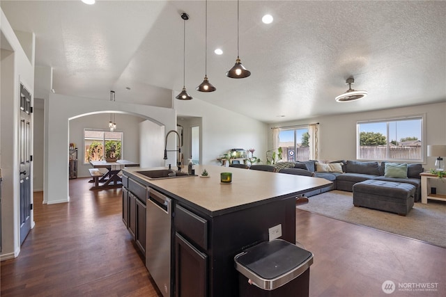 5421 Jackson Ln, Pasco, WA 99301 - kitchen featuring dishwasher, arched walkways, healthy amount of natural light, open floor plan, and a textured ceiling