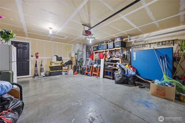 5421 Jackson Ln, Pasco, WA 99301 - garage featuring freestanding refrigerator and a garage door opener