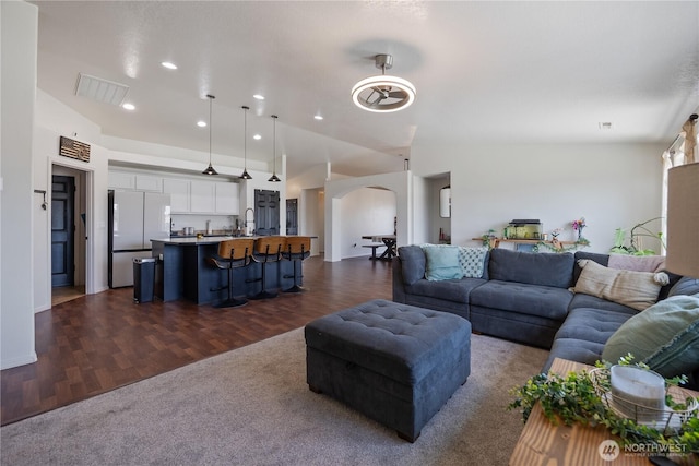 5421 Jackson Ln, Pasco, WA 99301 - living area featuring arched walkways, dark wood finished floors, and recessed lighting