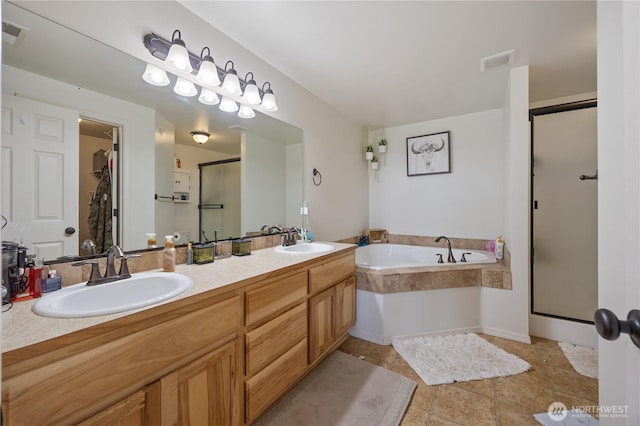 5421 Jackson Ln, Pasco, WA 99301 - bathroom featuring a shower stall, double vanity, a garden tub, and a spacious closet