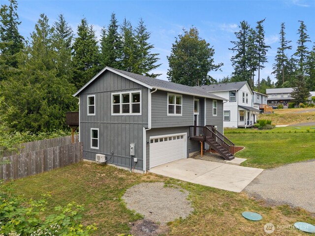 1172 Thorndyke Rd, Port Ludlow, WA 98365 - view of front facade featuring concrete driveway, an attached garage, and board and batten siding