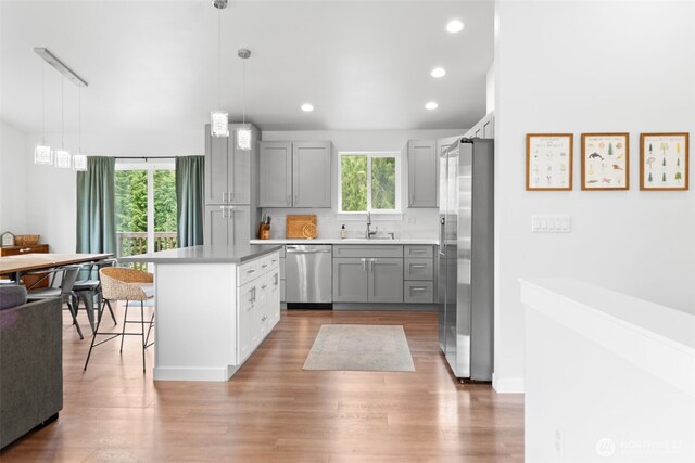 1172 Thorndyke Rd, Port Ludlow, WA 98365 - kitchen with stainless steel appliances, healthy amount of natural light, gray cabinetry, a kitchen bar, and recessed lighting