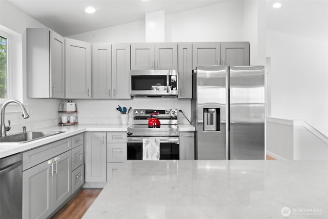 1172 Thorndyke Rd, Port Ludlow, WA 98365 - kitchen featuring stainless steel appliances, lofted ceiling, gray cabinetry, recessed lighting, and light stone countertops