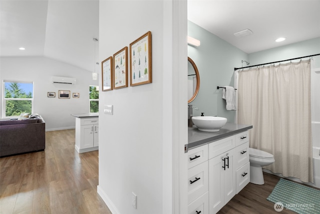 1172 Thorndyke Rd, Port Ludlow, WA 98365 - bathroom featuring a wall mounted AC, vanity, wood finished floors, shower / bathtub combination with curtain, and recessed lighting