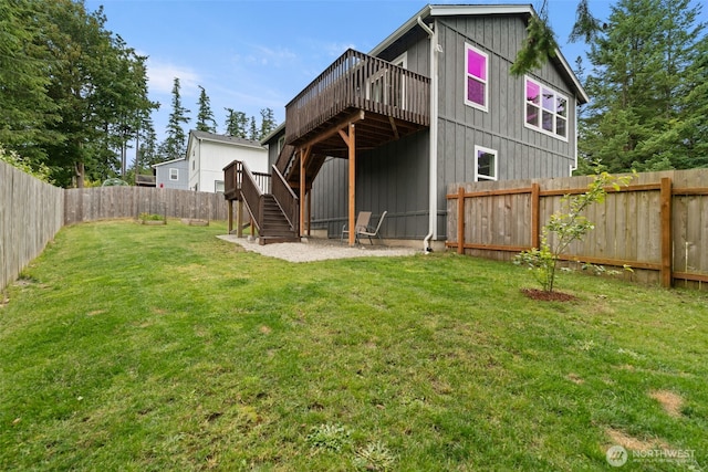 1172 Thorndyke Rd, Port Ludlow, WA 98365 - back of property featuring stairway, a deck, a fenced backyard, and board and batten siding