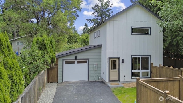 10342 39th Ave NE, Seattle, WA 98125 - view of front of house with board and batten siding, driveway, and an attached garage