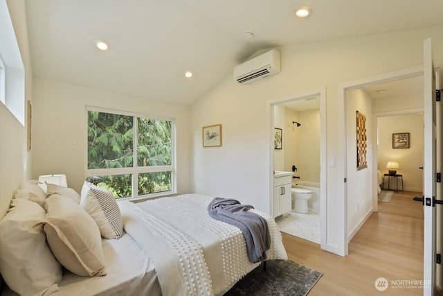 10342 39th Ave NE, Seattle, WA 98125 - bedroom with a wall mounted air conditioner, light wood-style flooring, vaulted ceiling, recessed lighting, and connected bathroom