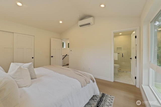 10342 39th Ave NE, Seattle, WA 98125 - bedroom with a wall mounted air conditioner, light wood-type flooring, vaulted ceiling, recessed lighting, and ensuite bathroom
