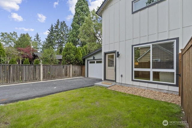 10342 39th Ave NE, Seattle, WA 98125 - view of yard featuring asphalt driveway and a garage