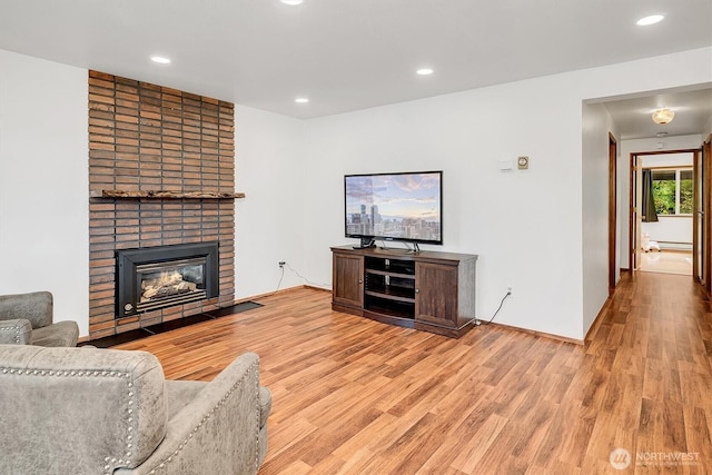921 Pershing Ave Unit 101, Bremerton, WA 98312 - living room with light wood-style floors, recessed lighting, a fireplace, and a baseboard radiator