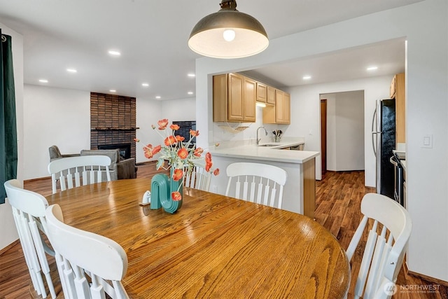 921 Pershing Ave Unit 101, Bremerton, WA 98312 - dining room with dark wood-style flooring, a fireplace, and recessed lighting