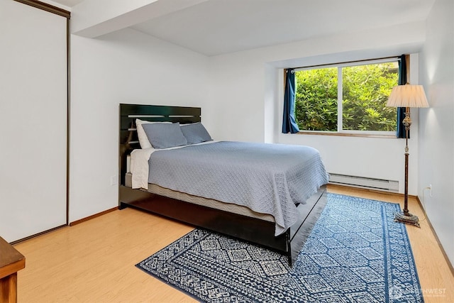921 Pershing Ave Unit 101, Bremerton, WA 98312 - bedroom with a baseboard heating unit and wood finished floors