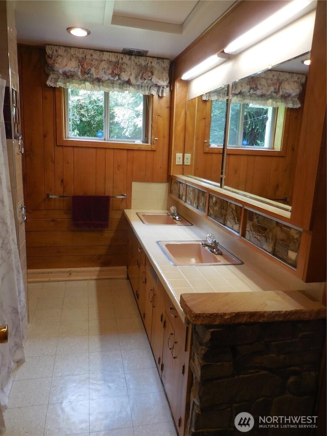 3649 Long Lake Rd SE, Port Orchard, WA 98366 - full bath featuring wooden walls, double vanity, and tile patterned floors