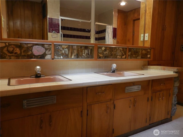 3649 Long Lake Rd SE, Port Orchard, WA 98366 - kitchen featuring tasteful backsplash and brown cabinetry