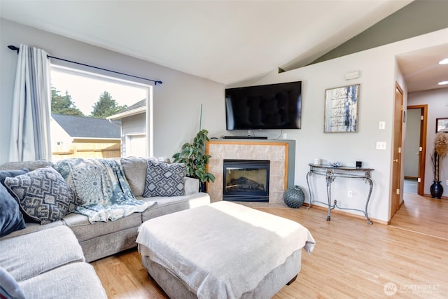858 Willow Ct SW, Ocean Shores, WA 98569 - living area with lofted ceiling, light wood-style floors, and a tile fireplace