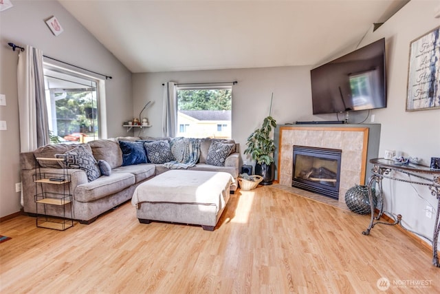 858 Willow Ct SW, Ocean Shores, WA 98569 - living area featuring vaulted ceiling, wood finished floors, and a fireplace