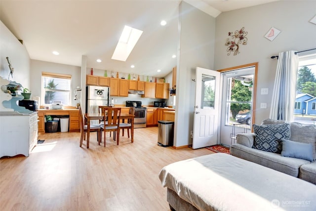 858 Willow Ct SW, Ocean Shores, WA 98569 - living area featuring a skylight, healthy amount of natural light, light wood finished floors, high vaulted ceiling, and recessed lighting