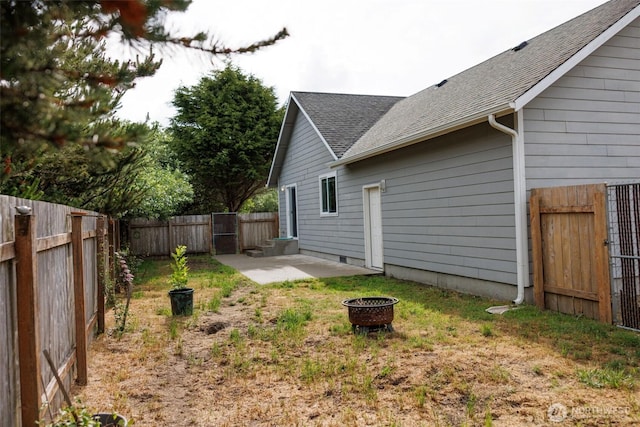 858 Willow Ct SW, Ocean Shores, WA 98569 - fenced backyard featuring a fire pit and a patio area