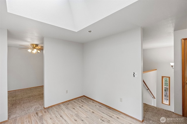 1563 Nylace Ln SE, Port Orchard, WA 98367 - spare room featuring light wood finished floors, a ceiling fan, and a skylight