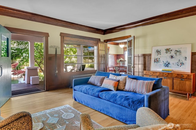 4926 42nd Ave S, Seattle, WA 98118 - living room with ornamental molding, plenty of natural light, a wainscoted wall, and light wood-type flooring