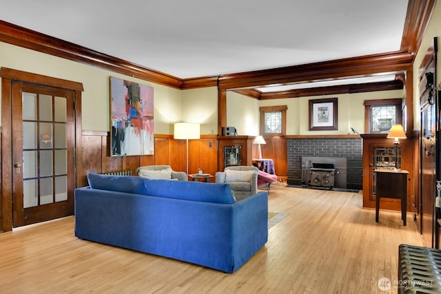 4926 42nd Ave S, Seattle, WA 98118 - living room with ornamental molding, a fireplace, a wainscoted wall, and wood-type flooring