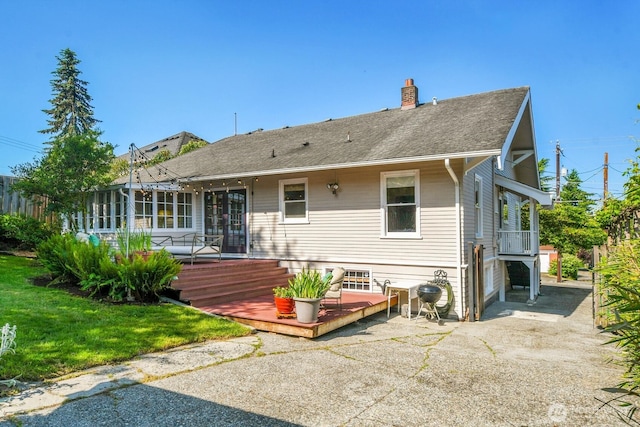 4926 42nd Ave S, Seattle, WA 98118 - rear view of house with a wooden deck, a chimney, and a shingled roof