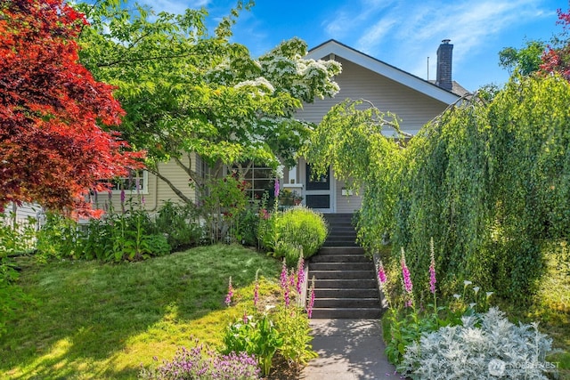 4926 42nd Ave S, Seattle, WA 98118 - obstructed view of property with stairs, a chimney, and a front yard