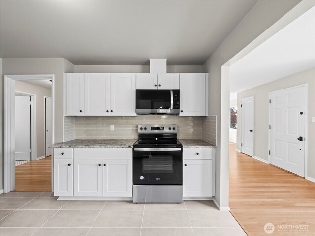 4510 N 24th St, Tacoma, WA 98406 - kitchen with stainless steel appliances, white cabinets, backsplash, and light stone counters