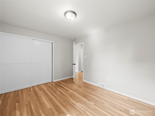 4510 N 24th St, Tacoma, WA 98406 - unfurnished bedroom with light wood-style flooring and a closet