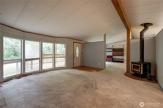 31109 202nd Ave SE, Kent, WA 98042 - unfurnished living room with carpet flooring, a wood stove, and lofted ceiling