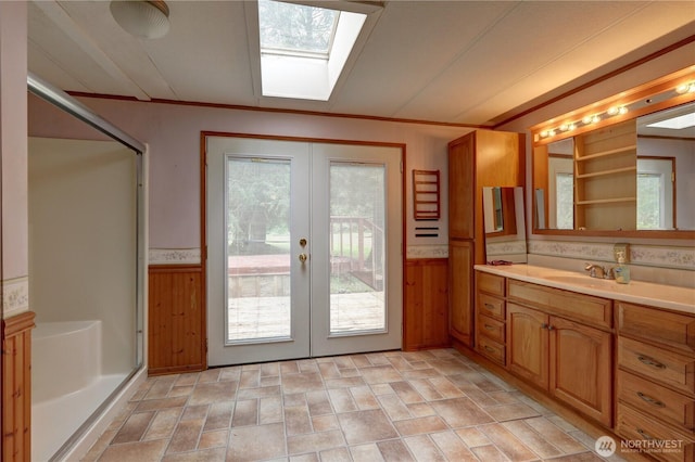 31109 202nd Ave SE, Kent, WA 98042 - full bathroom featuring french doors, a skylight, vanity, a shower stall, and wooden walls