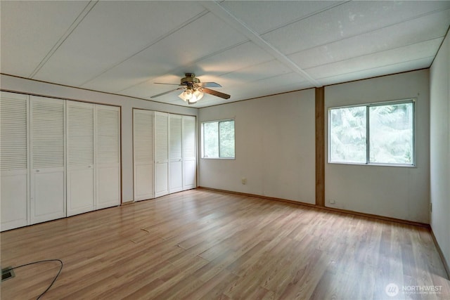 31109 202nd Ave SE, Kent, WA 98042 - unfurnished bedroom with multiple closets, light wood finished floors, and ceiling fan