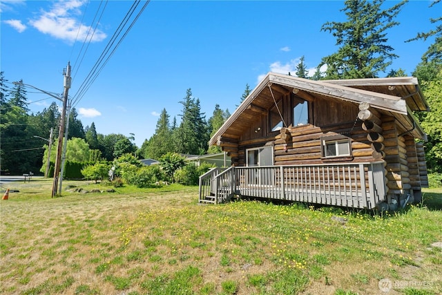 8669 Harbor Dr, Blaine, WA 98230 - view of home's exterior featuring log siding, a deck, and a lawn