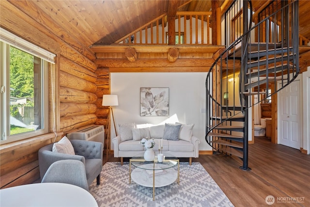 8669 Harbor Dr, Blaine, WA 98230 - living room featuring rustic walls, vaulted ceiling, an AC wall unit, stairway, and wood finished floors