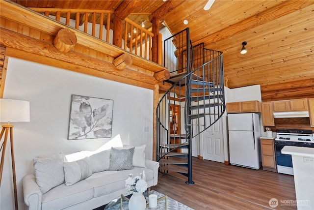 8669 Harbor Dr, Blaine, WA 98230 - living area with high vaulted ceiling, wood ceiling, dark wood-type flooring, and stairway