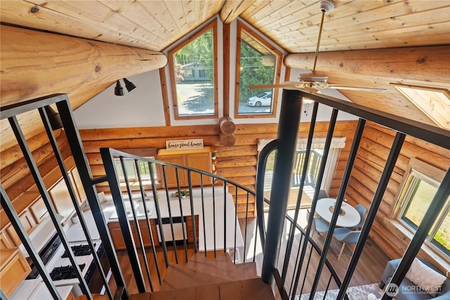 8669 Harbor Dr, Blaine, WA 98230 - staircase with log walls, hardwood / wood-style floors, wood ceiling, a ceiling fan, and vaulted ceiling