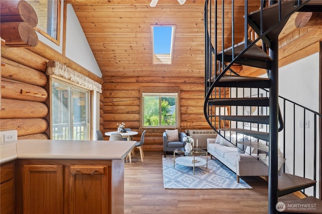 8669 Harbor Dr, Blaine, WA 98230 - living room featuring stairs, vaulted ceiling, rustic walls, wood finished floors, and wooden ceiling