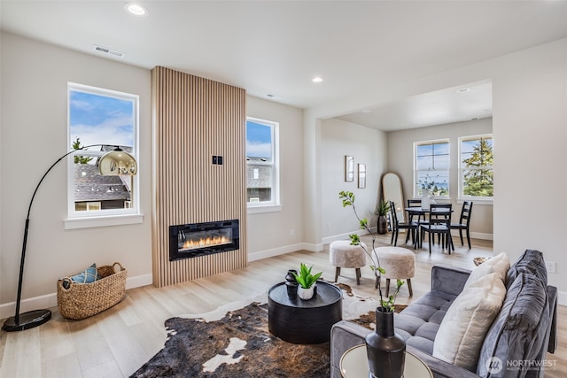 3606 E M St, Tacoma, WA 98404 - living room featuring light wood finished floors, healthy amount of natural light, a glass covered fireplace, and recessed lighting