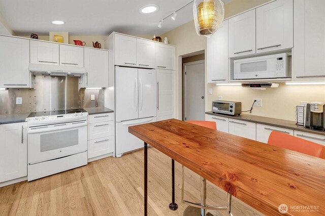 6713 128th Ave SE, Bellevue, WA 98006 - kitchen featuring white appliances, under cabinet range hood, white cabinetry, dark countertops, and light wood-style floors