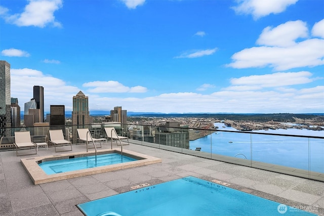 300 Virginia St Unit 1311, Seattle, WA 98101 - view of swimming pool featuring a hot tub, a skyline view, and a pool