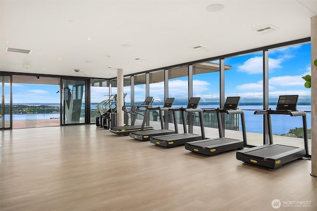 300 Virginia St Unit 1311, Seattle, WA 98101 - workout area featuring expansive windows, wood finished floors, and a water view