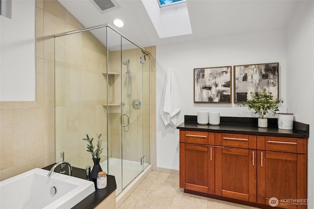 1564 Hillside Dr SE, Issaquah, WA 98027 - bathroom featuring a skylight, a stall shower, a garden tub, and tile patterned floors