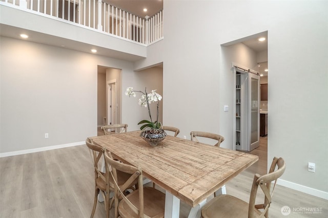 16321 SE 133rd Pl, Renton, WA 98059 - dining space with light wood-style flooring, a towering ceiling, and recessed lighting