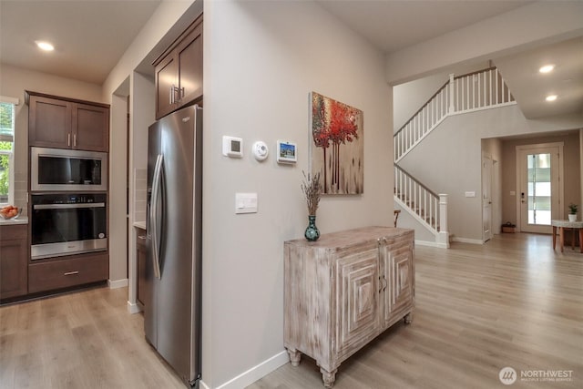 16321 SE 133rd Pl, Renton, WA 98059 - kitchen featuring stainless steel appliances, light wood-style flooring, recessed lighting, dark brown cabinetry, and light countertops