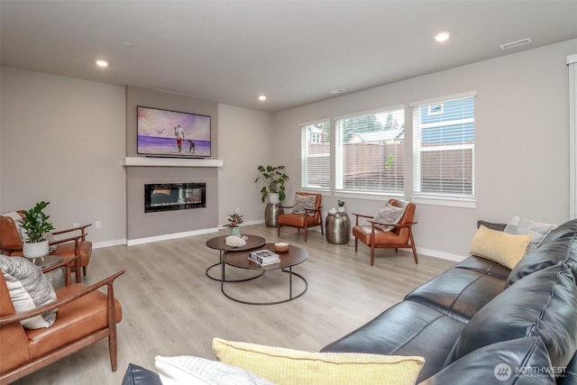 16321 SE 133rd Pl, Renton, WA 98059 - living area with wood finished floors, a glass covered fireplace, and recessed lighting