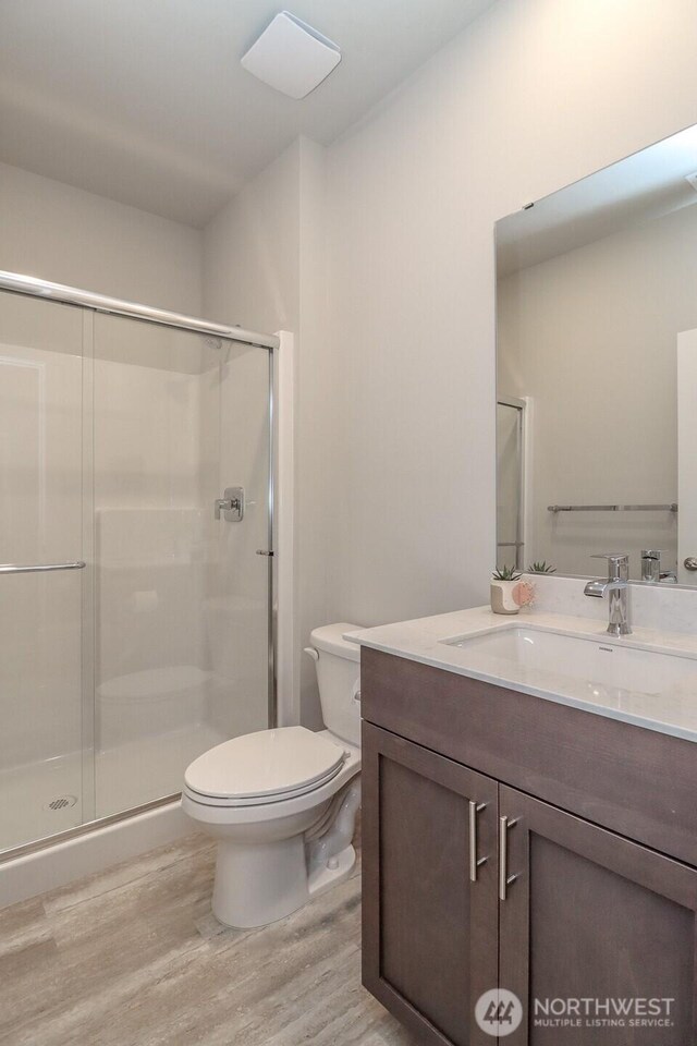 16321 SE 133rd Pl, Renton, WA 98059 - bathroom with vanity, a shower stall, and wood finished floors
