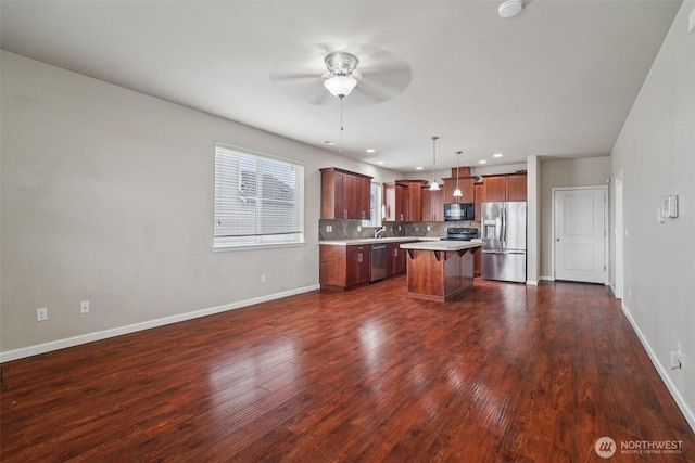 14403 Lockwood Ln SE, Yelm, WA 98597 - kitchen featuring black appliances, a ceiling fan, light countertops, a kitchen bar, and a kitchen island