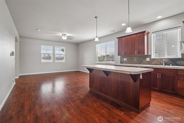 14403 Lockwood Ln SE, Yelm, WA 98597 - kitchen featuring plenty of natural light, a breakfast bar, dark wood-style flooring, a center island, and recessed lighting