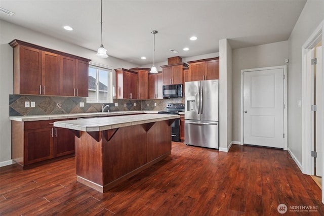 14403 Lockwood Ln SE, Yelm, WA 98597 - kitchen with stainless steel fridge with ice dispenser, black microwave, range with electric stovetop, tile counters, and backsplash